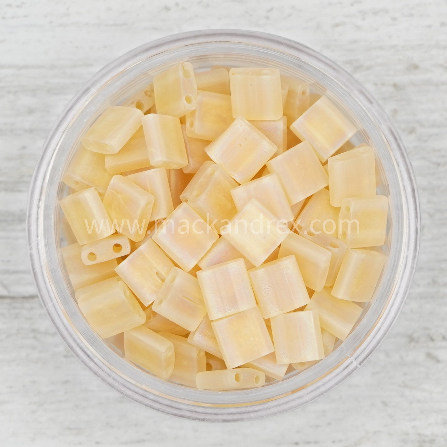 a bowl of diced cheese on a white wooden table