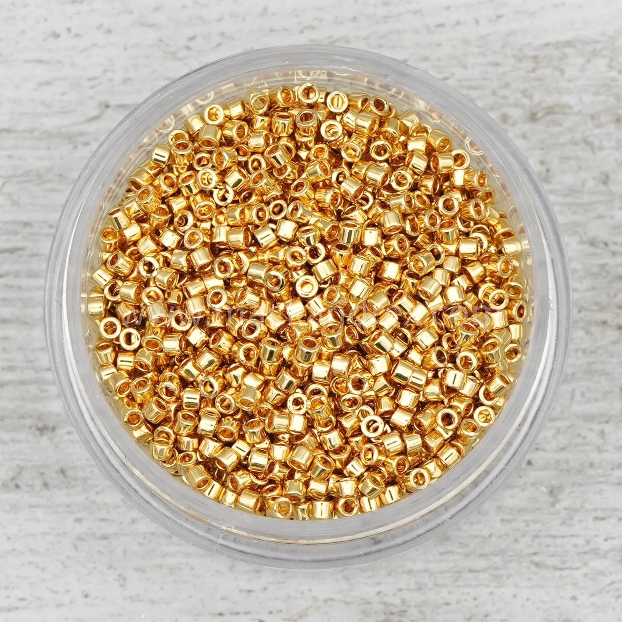 a bowl filled with gold colored beads
