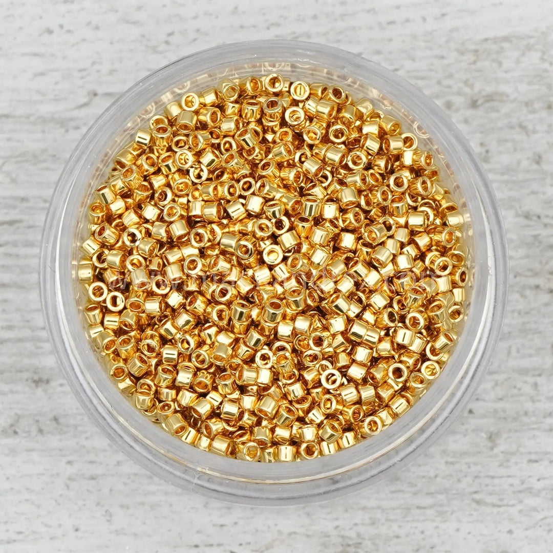 a bowl filled with gold colored beads