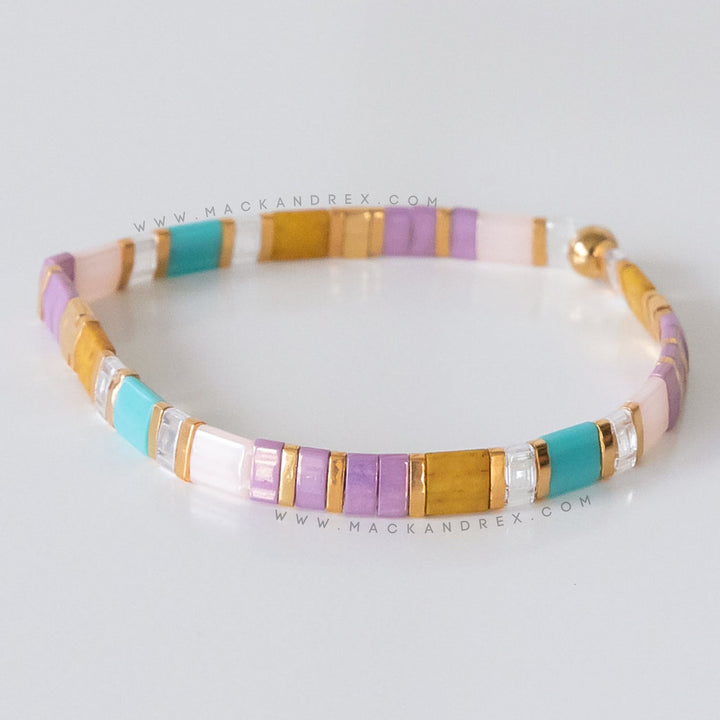 a close up of a bracelet on a white surface