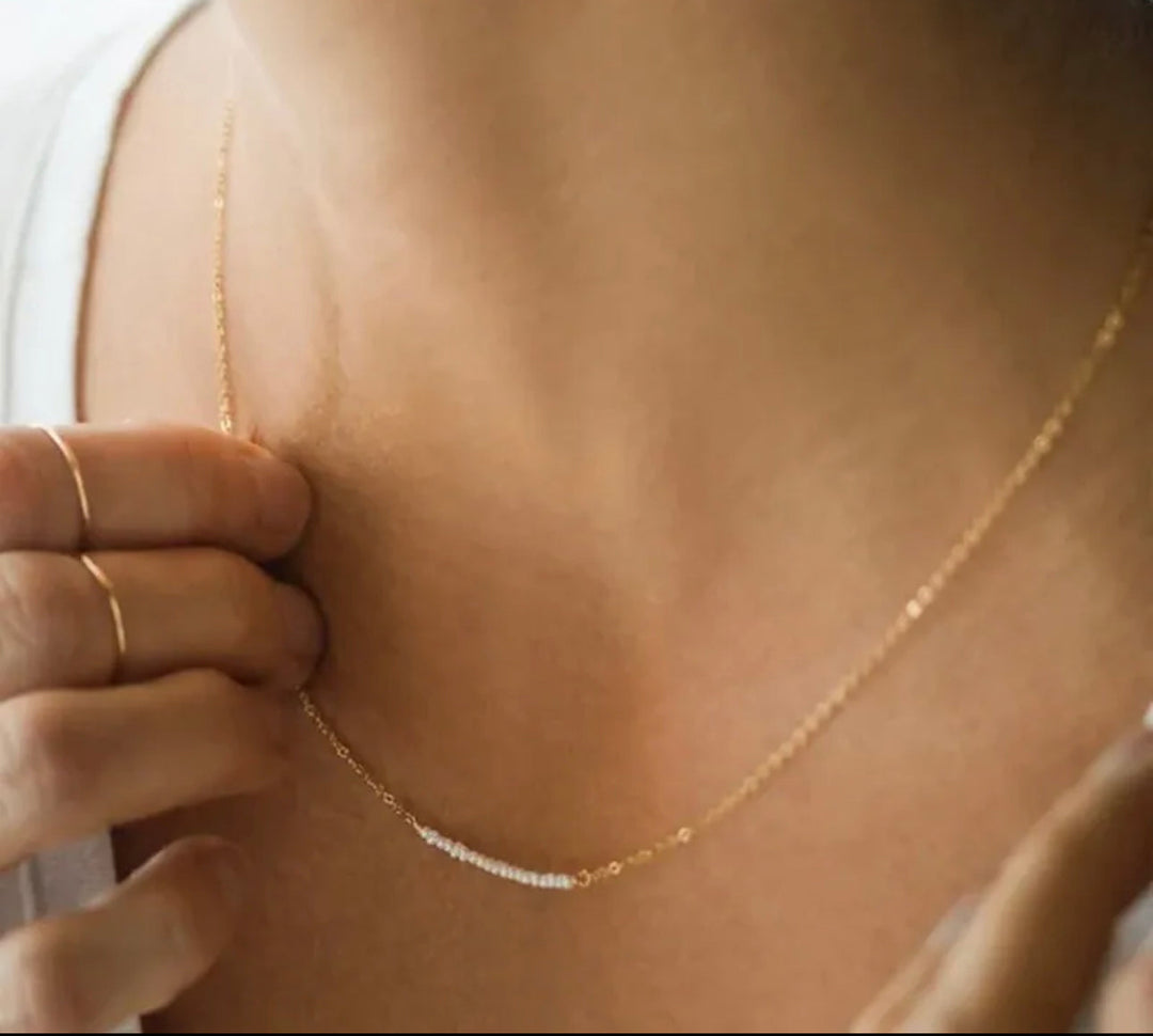 a close up of a person wearing a necklace