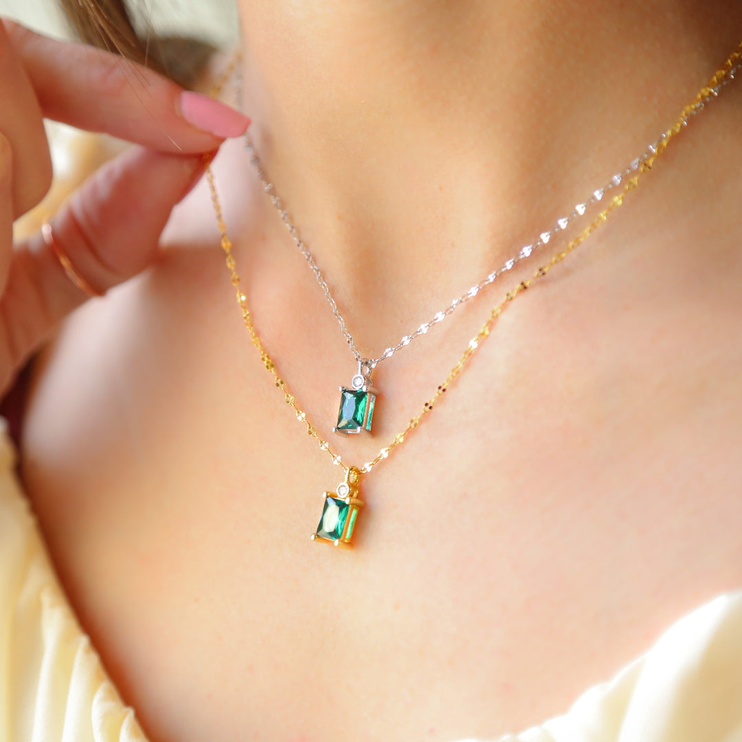 a close up of a person wearing a necklace