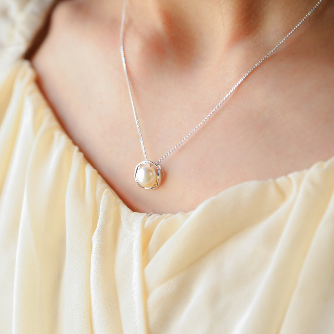 a close up of a woman wearing a necklace
