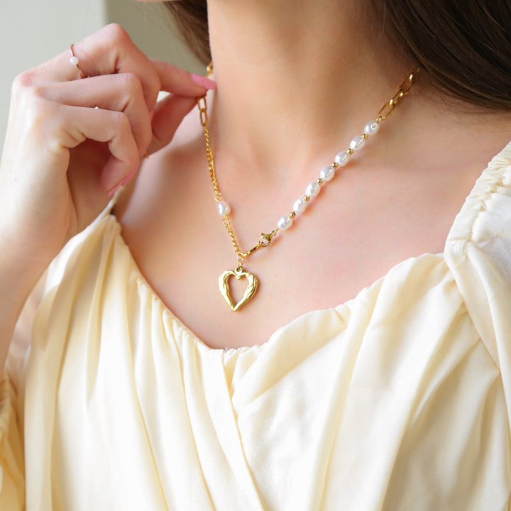 a woman wearing a necklace with a heart charm