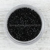black seed beads in a plastic container