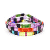 a stack of multicolored bracelets on a white background