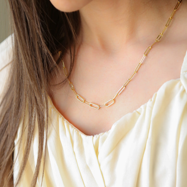 a close up of a woman wearing a necklace