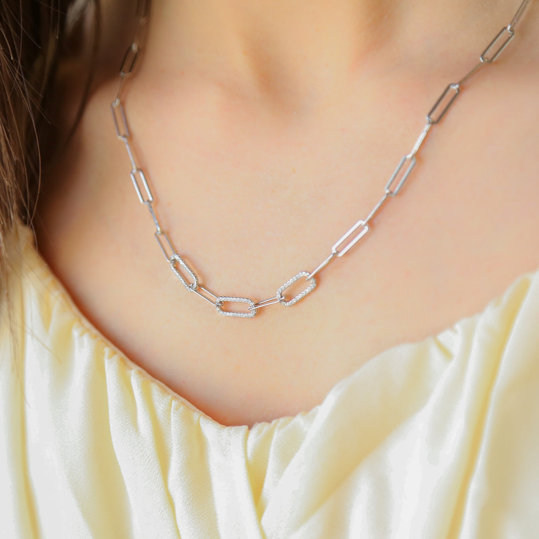 a close up of a woman wearing a necklace