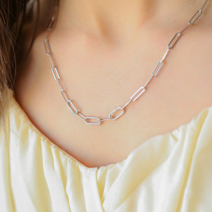 a close up of a woman wearing a necklace