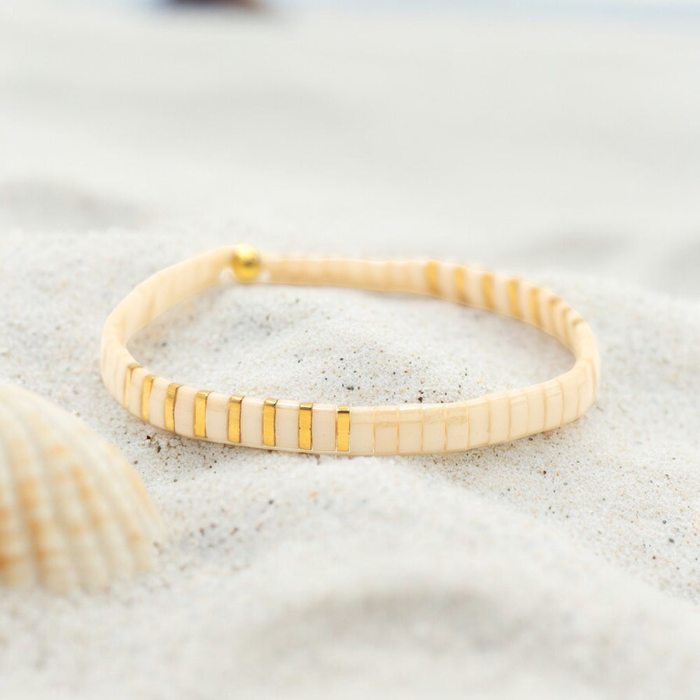 a close up of a bracelet on a beach