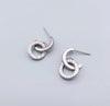 a pair of earrings on a gray background