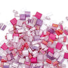 a pile of pink and purple cubes on a white surface