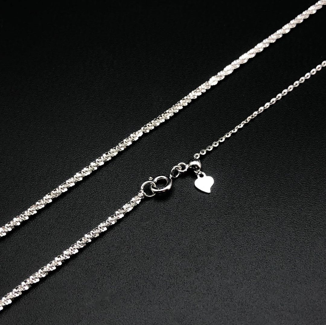 a silver chain with a heart on it