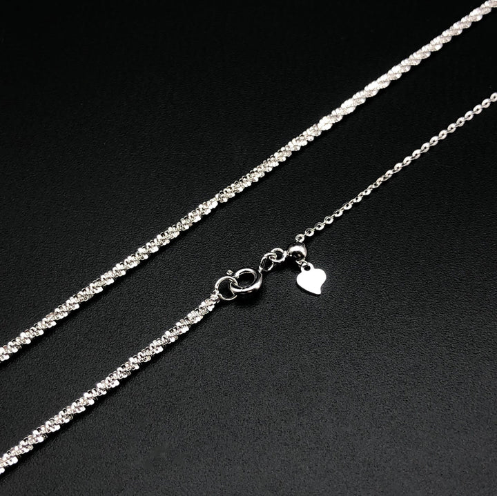 a silver chain with a heart on it