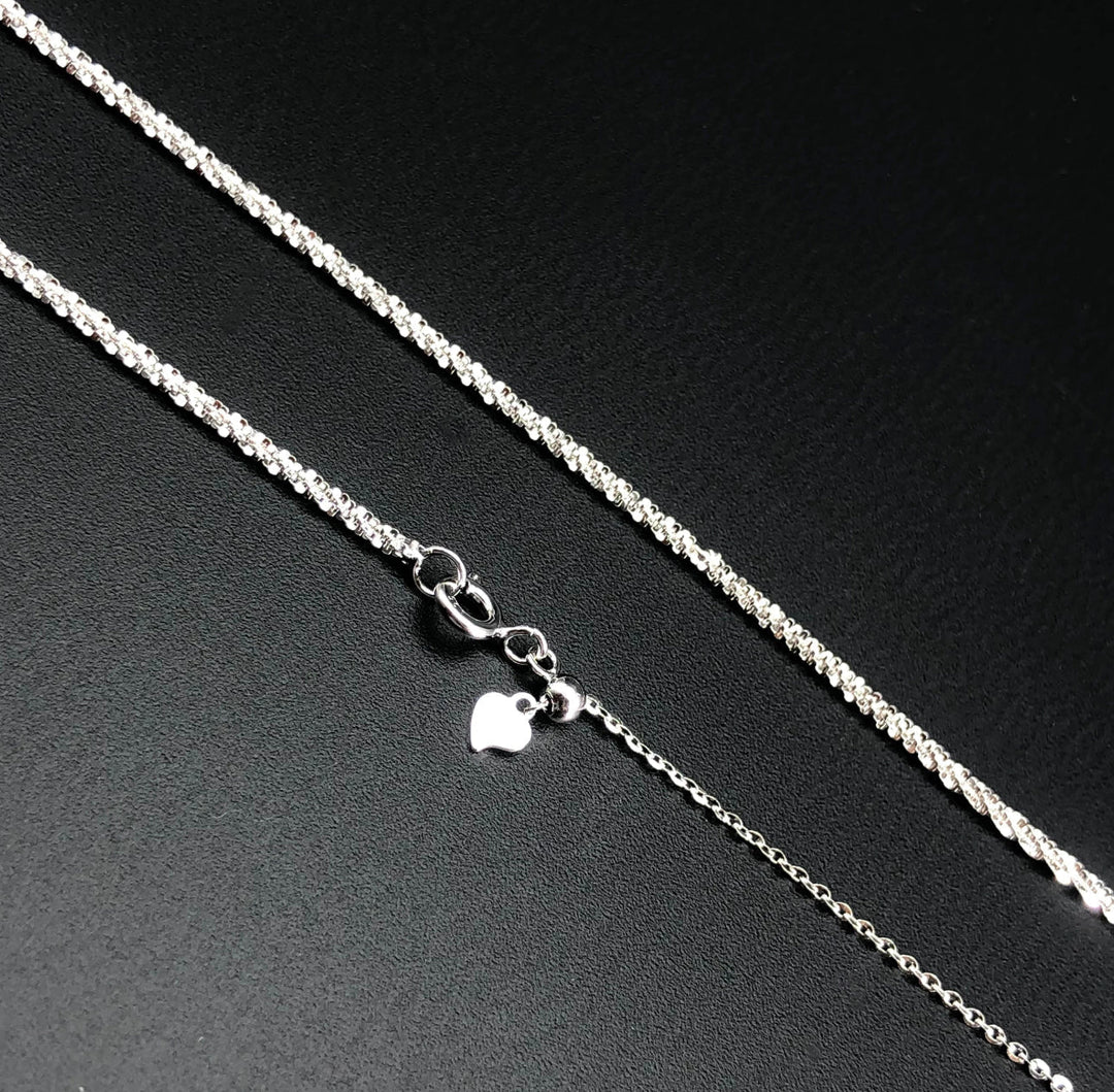 a silver chain with a heart on it
