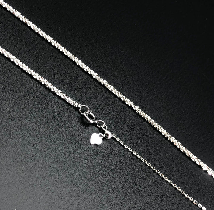 a silver chain with a heart on it
