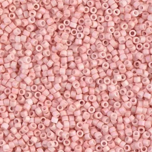a close up of a pink seed bead