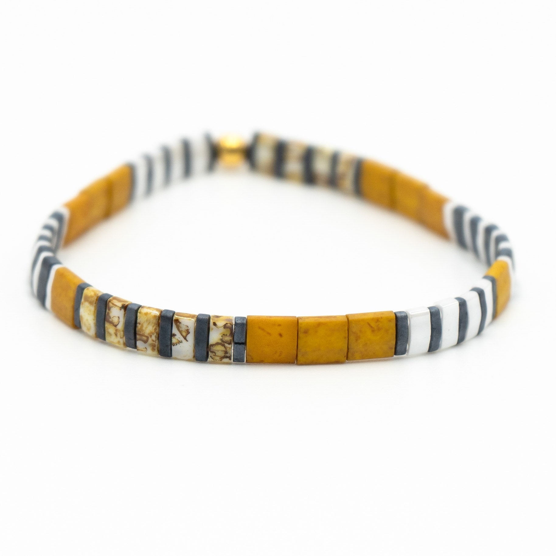 a yellow and black beaded bracelet on a white background