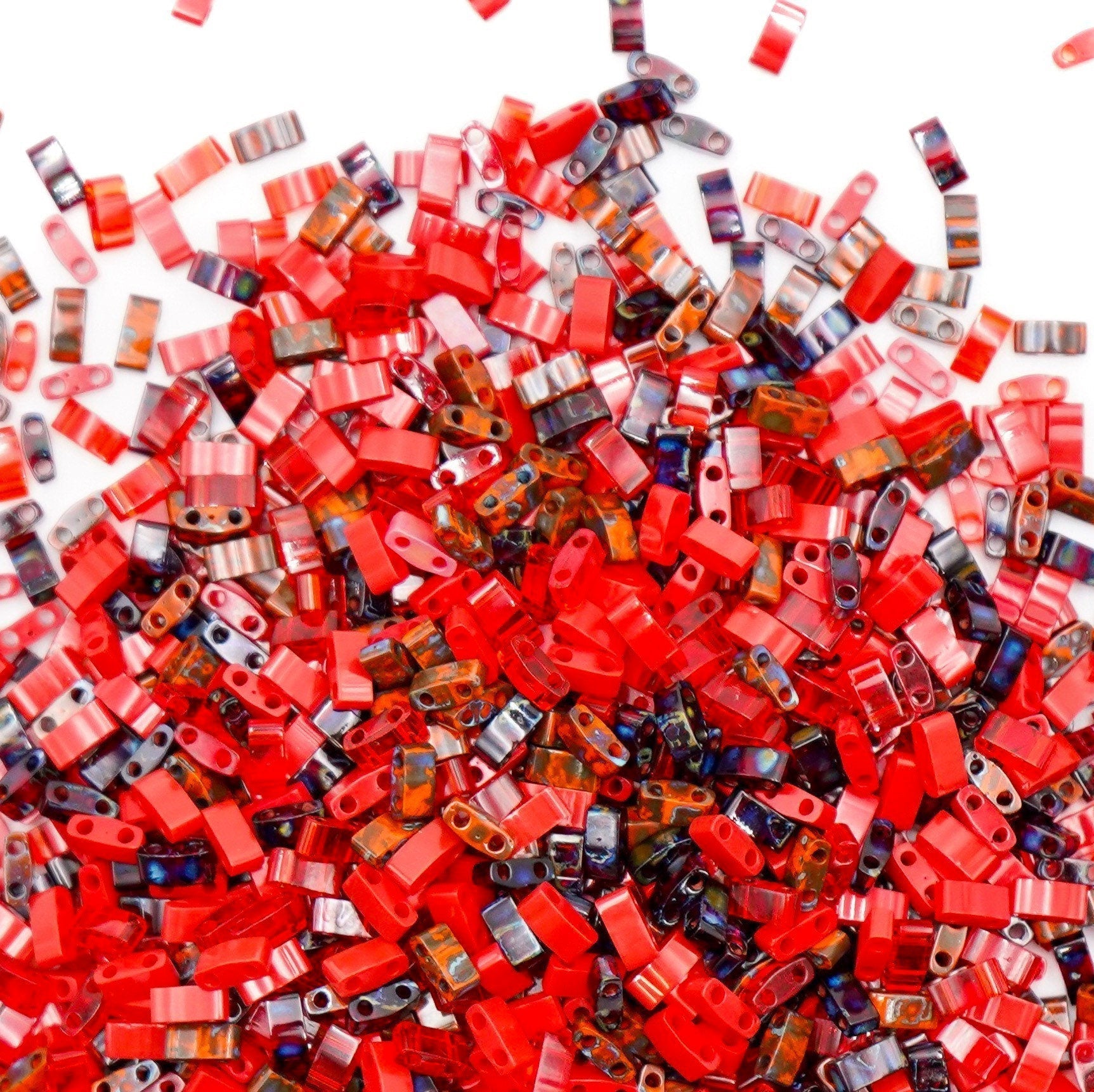 a pile of red and brown beads on a table