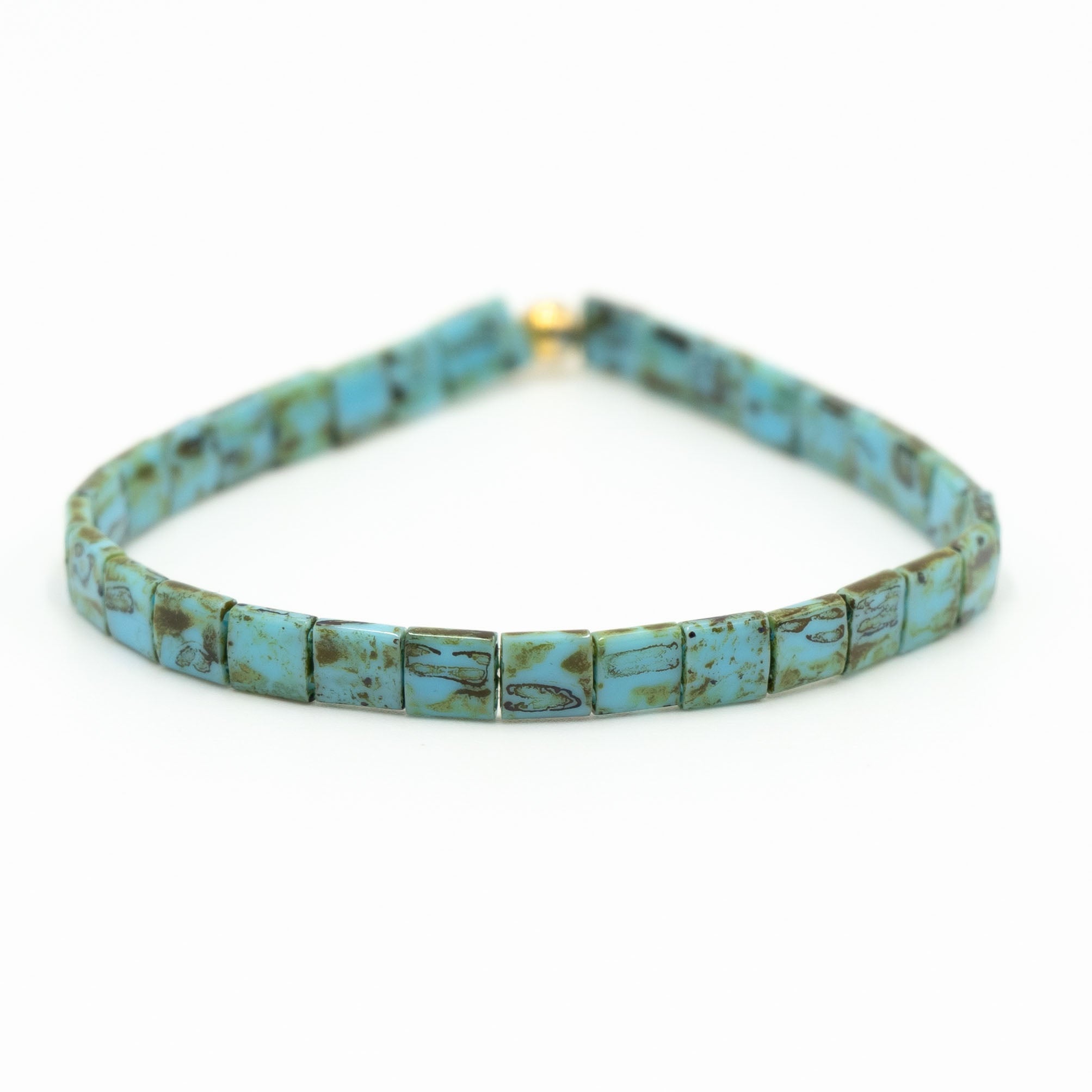 a bracelet made of turquoise beads on a white background