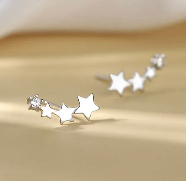 a pair of silver stars are on a table