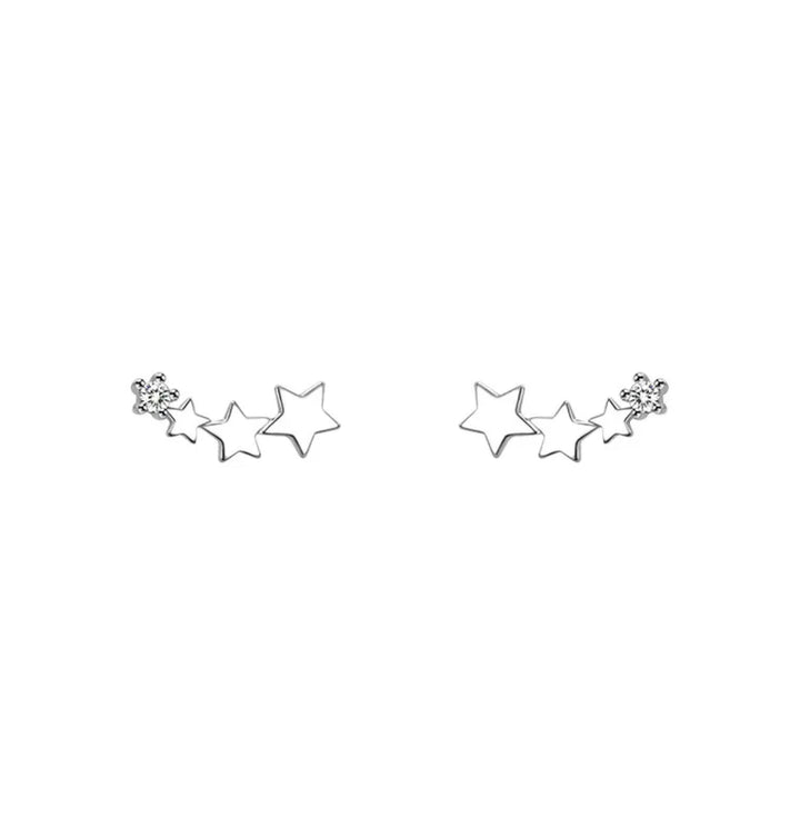 a pair of star shaped earrings on a white background