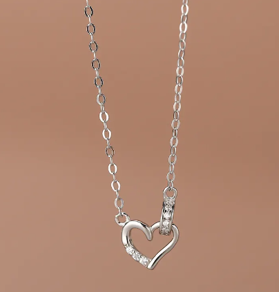 a necklace with a heart on a chain