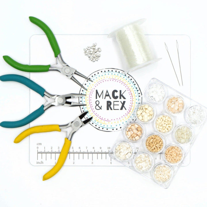 a pair of scissors, thread, and spools of thread sitting on a