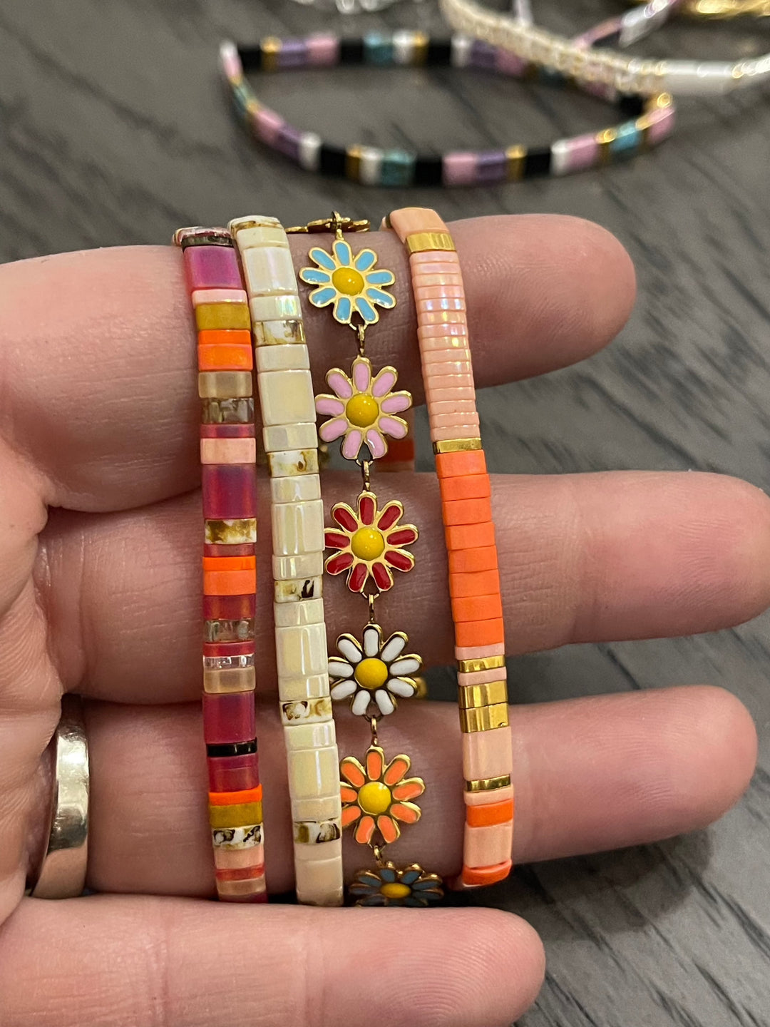 a person holding a bunch of bracelets in their hand