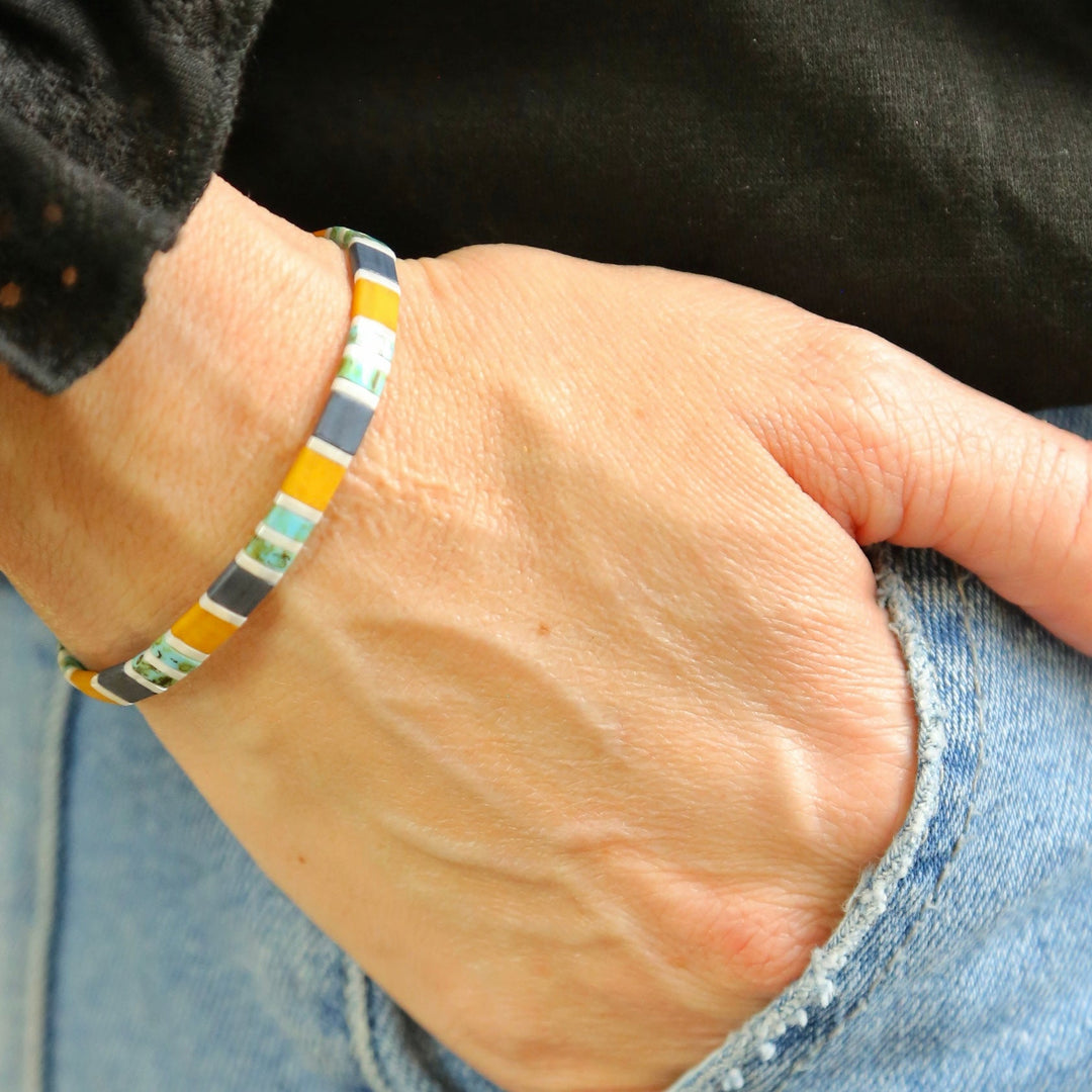 a person wearing a colorful bracelet and a black shirt