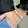 a person wearing a bracelet with a toothpick on it