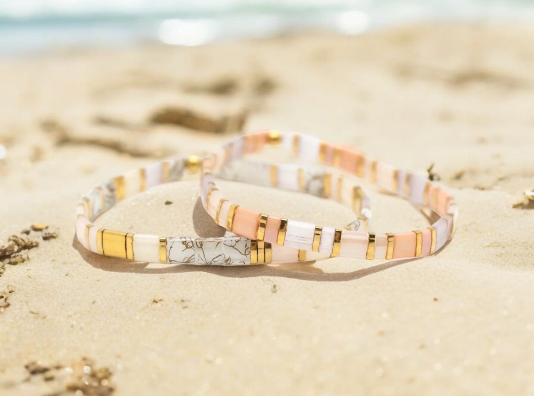 There is a couple bracelets on a beach