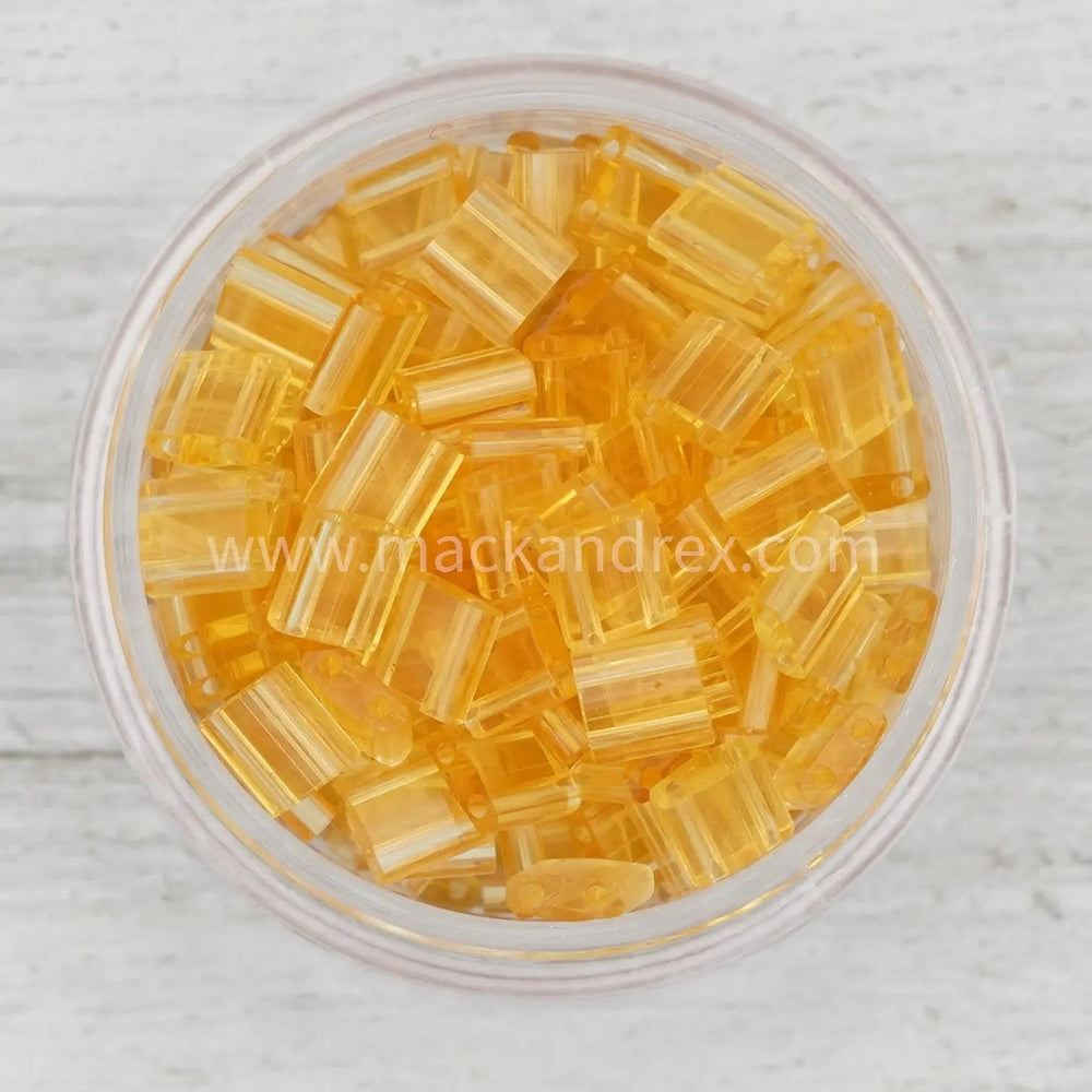 a glass bowl filled with yellow glass cubes