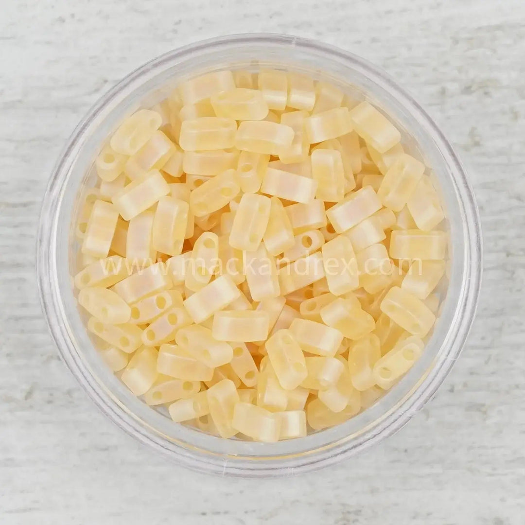 a bowl filled with yellow plastic beads on top of a table