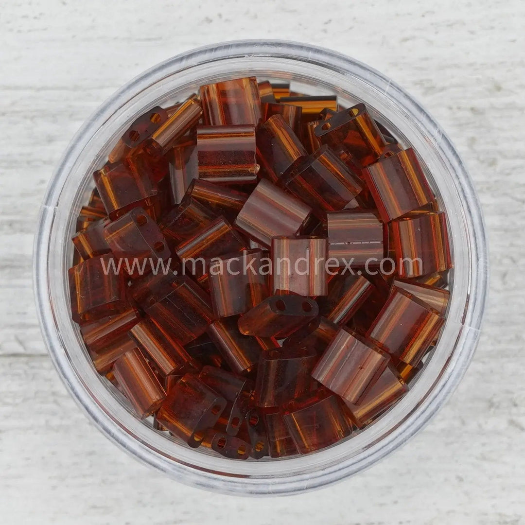 a bowl filled with lots of brown glass beads