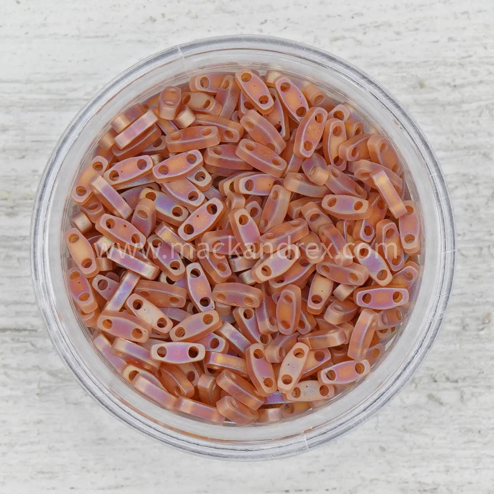 a bowl filled with lots of orange colored beads