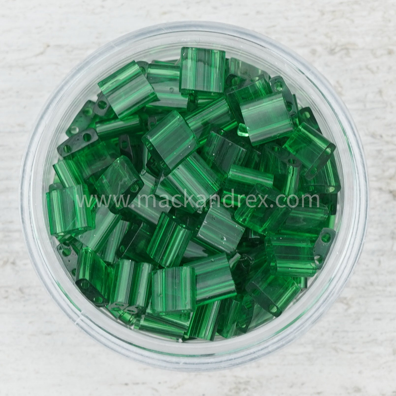 a bowl filled with green glass beads