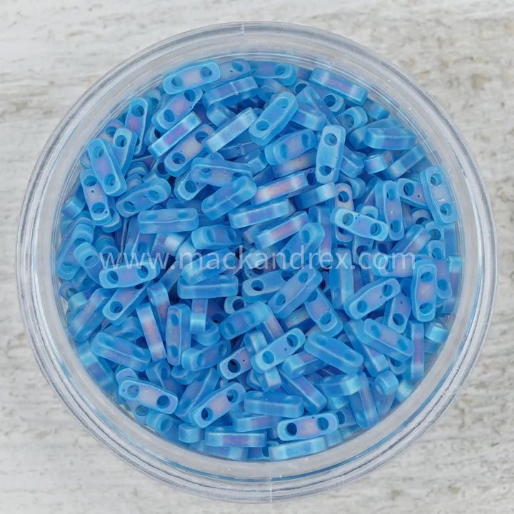 a bowl filled with blue beads on top of a table