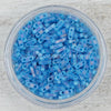 Load image into Gallery viewer, a bowl filled with blue beads on top of a table