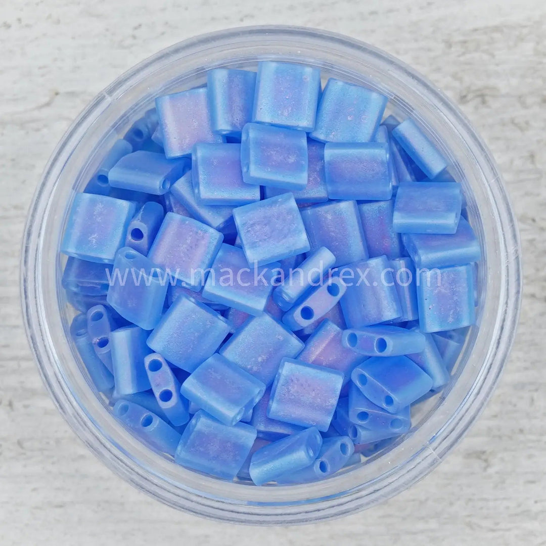 a bowl filled with blue beads on top of a table