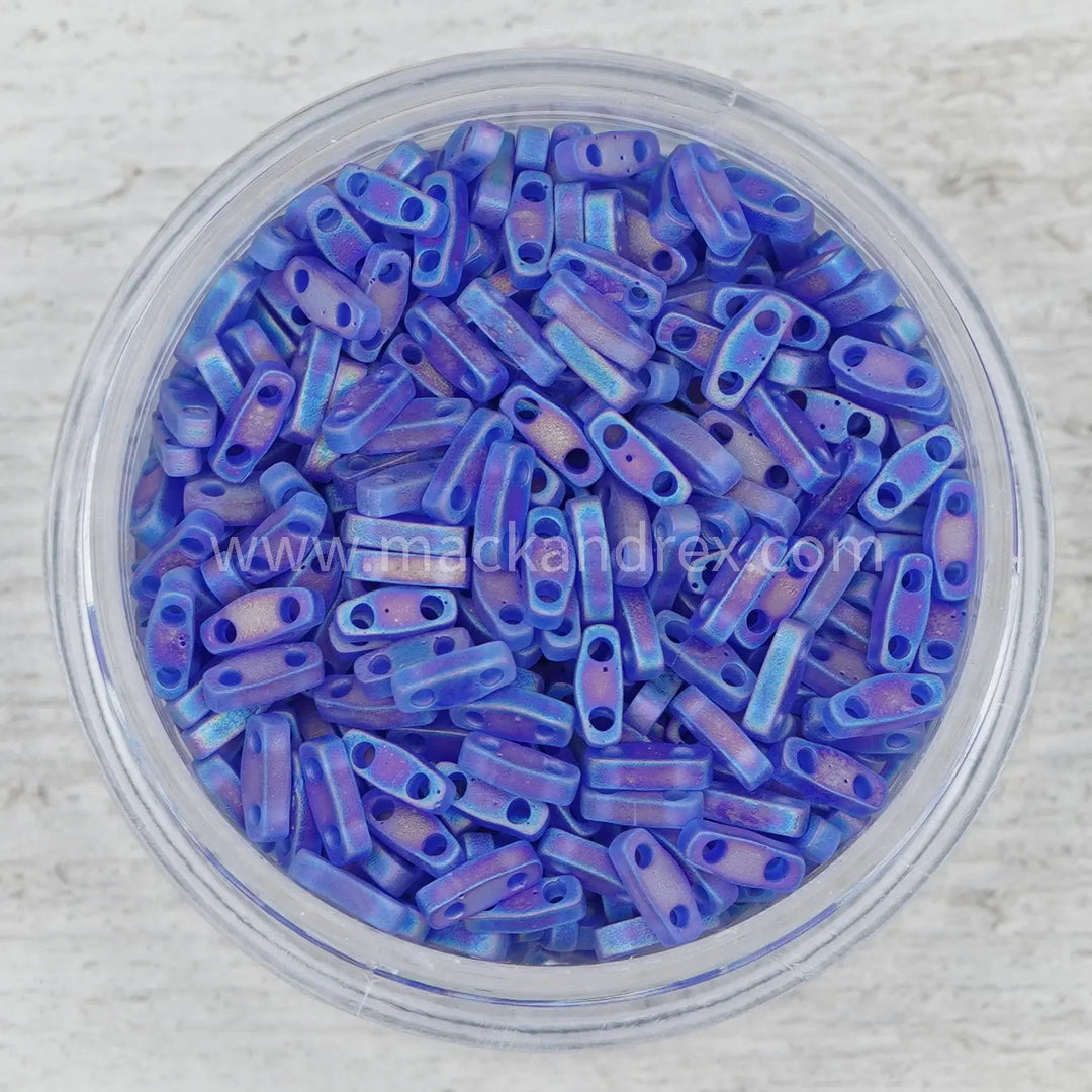 a bowl filled with blue beads on top of a table