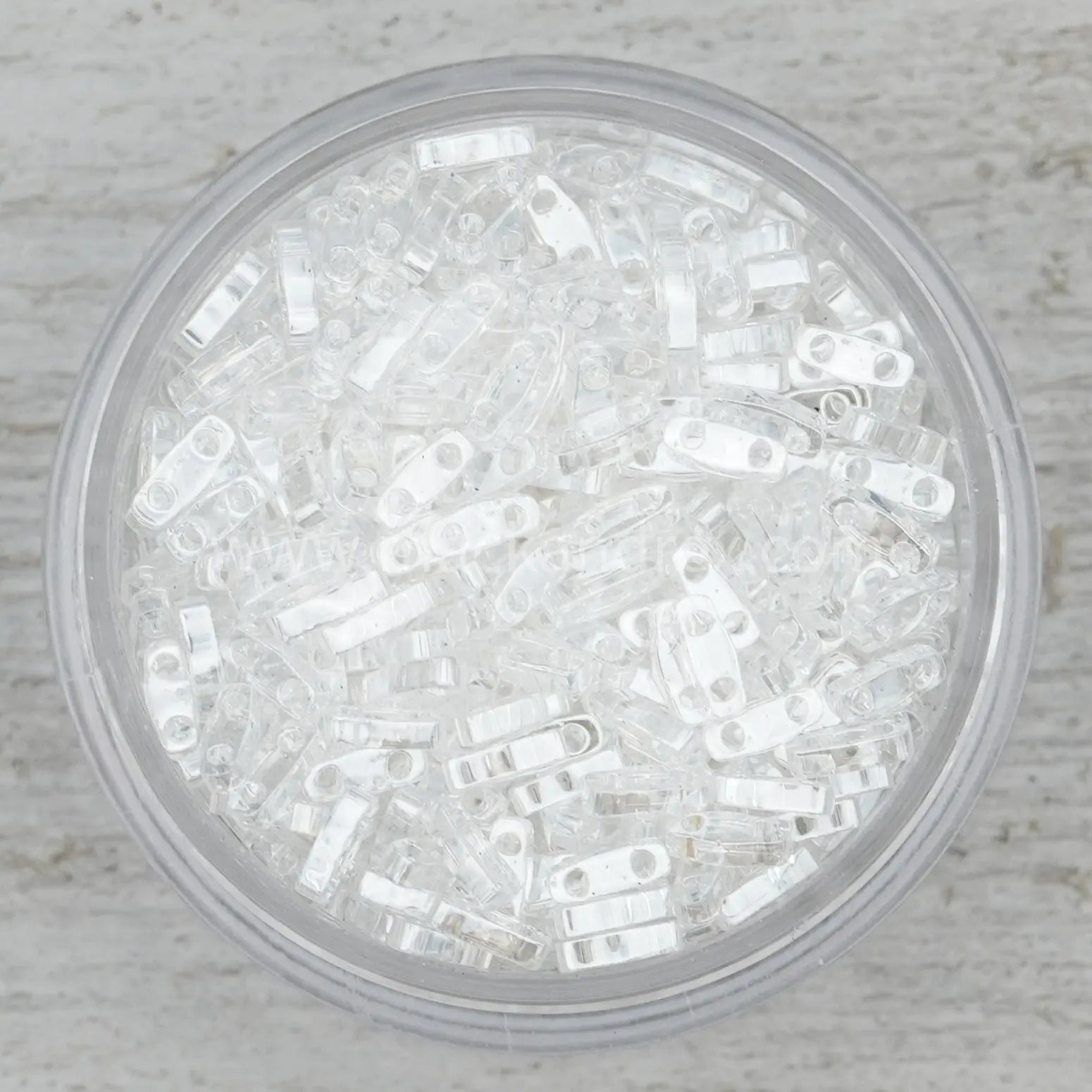 a plastic container filled with lots of white beads