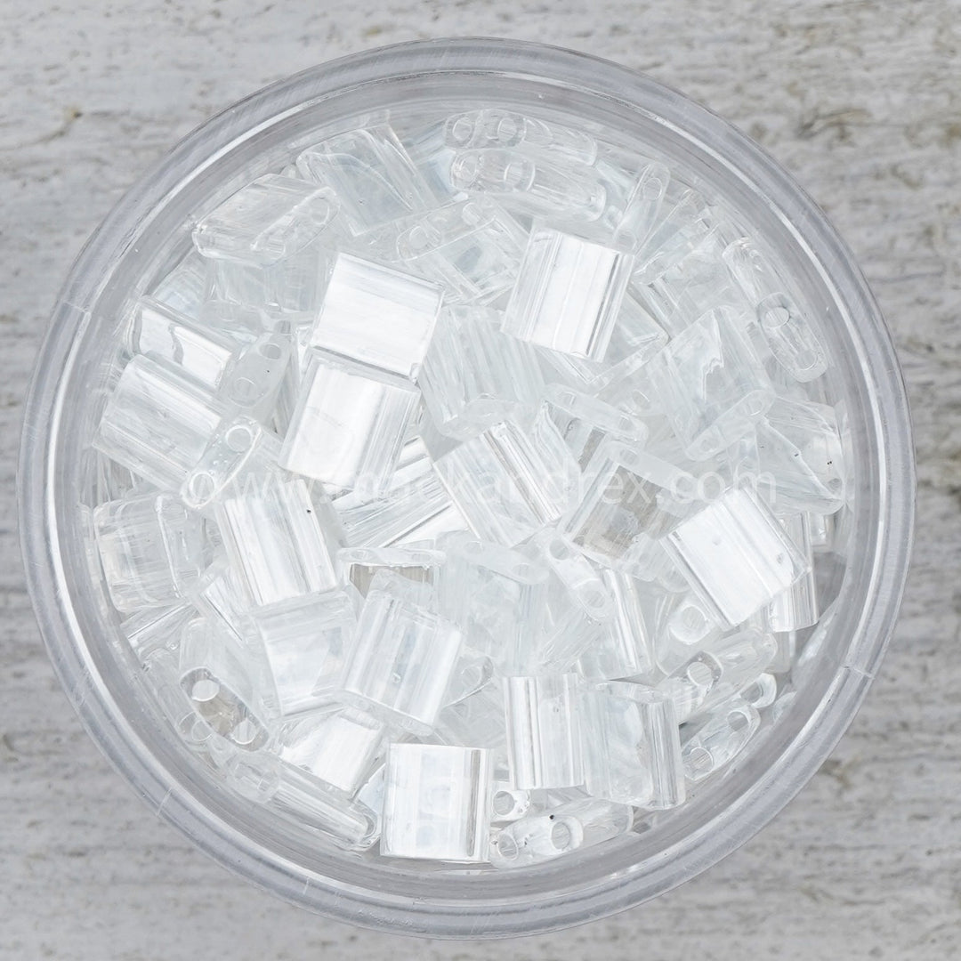 a glass bowl filled with clear plastic beads