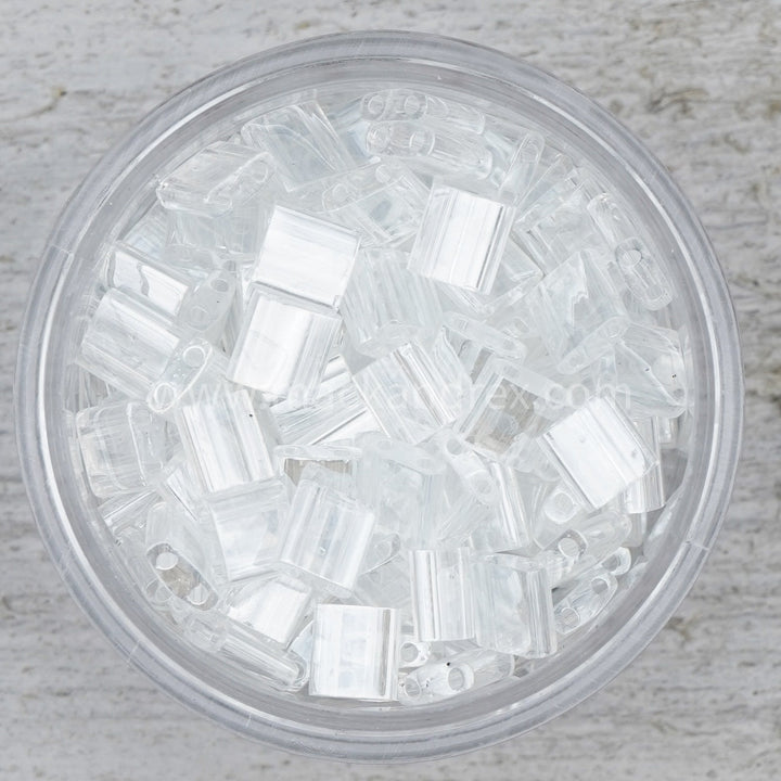a glass bowl filled with clear plastic beads