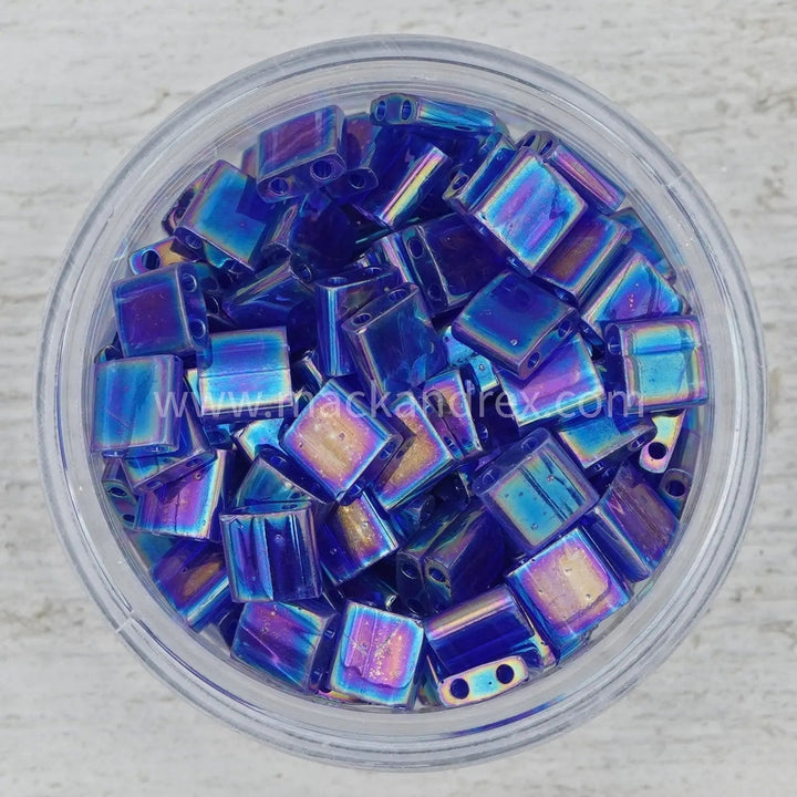 a bowl filled with blue and purple glass beads
