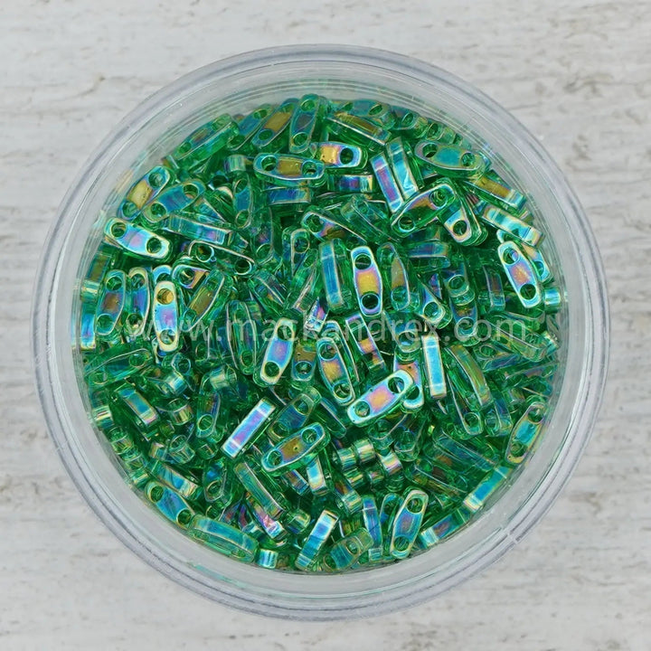 a bowl filled with lots of green beads