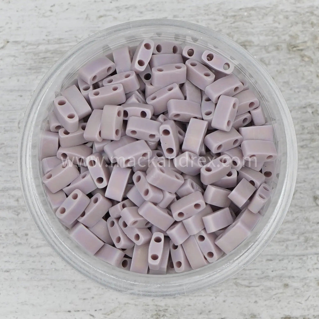 a bowl filled with lots of grey plastic beads