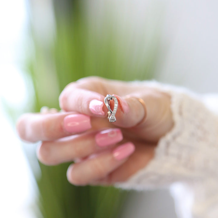 a woman holding a ring in her hand