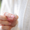 a woman is holding a ring in her hand