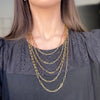 a woman wearing a black shirt and a gold chain necklace